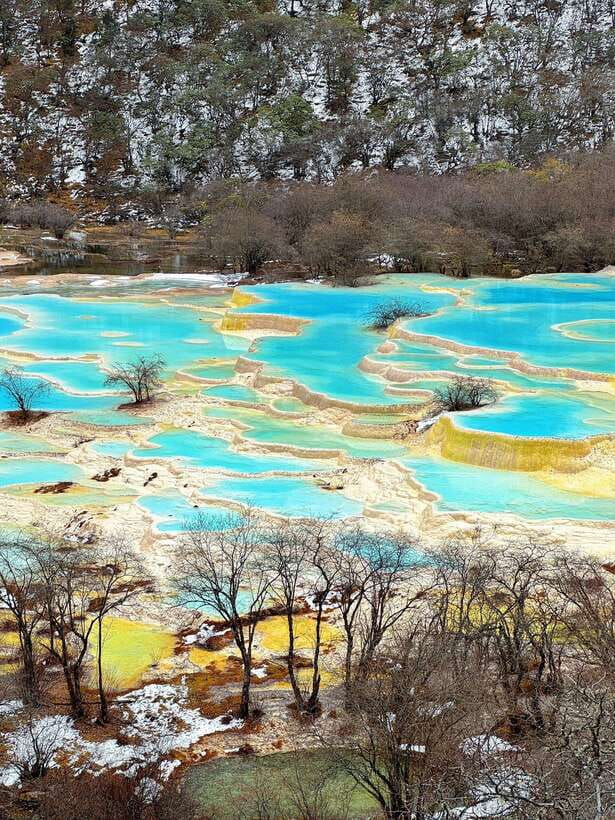 Huanglong Scenic Area: Explore Stunning Five-Colored Ponds - Five-Colored Ponds and the terraced travertine effect
